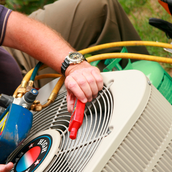 hvac specialist fixing an air conditioning unit