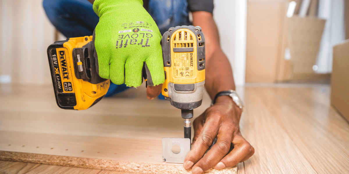 carpenter using a dewalt max 20 cordless drill