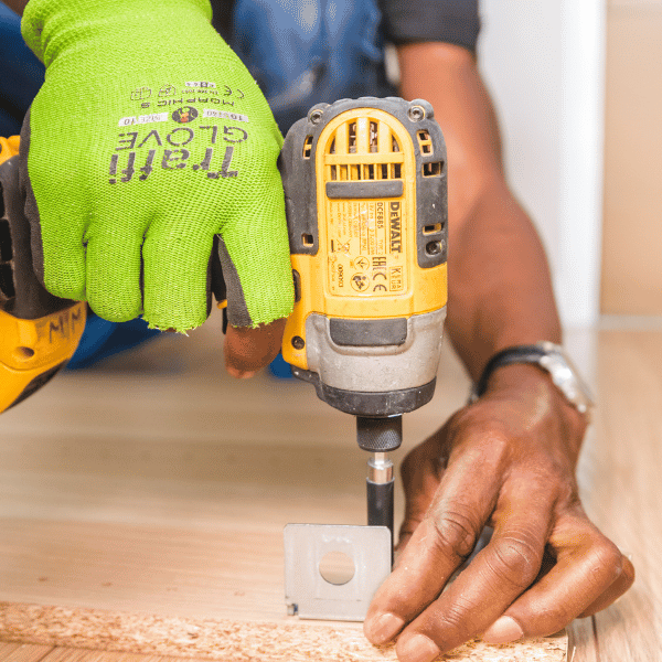 carpenter using a dewalt max 20 cordless drill