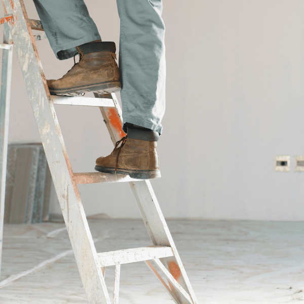 picture of a carpenters shoes stepping up a ladder