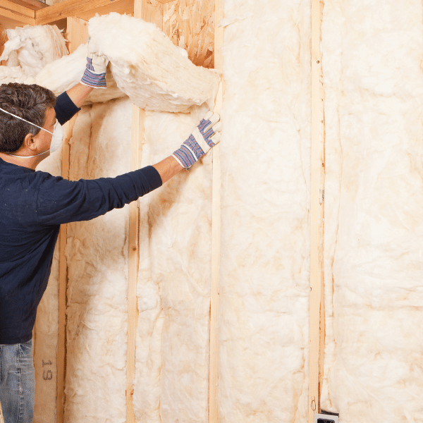 carpenter installing insulation