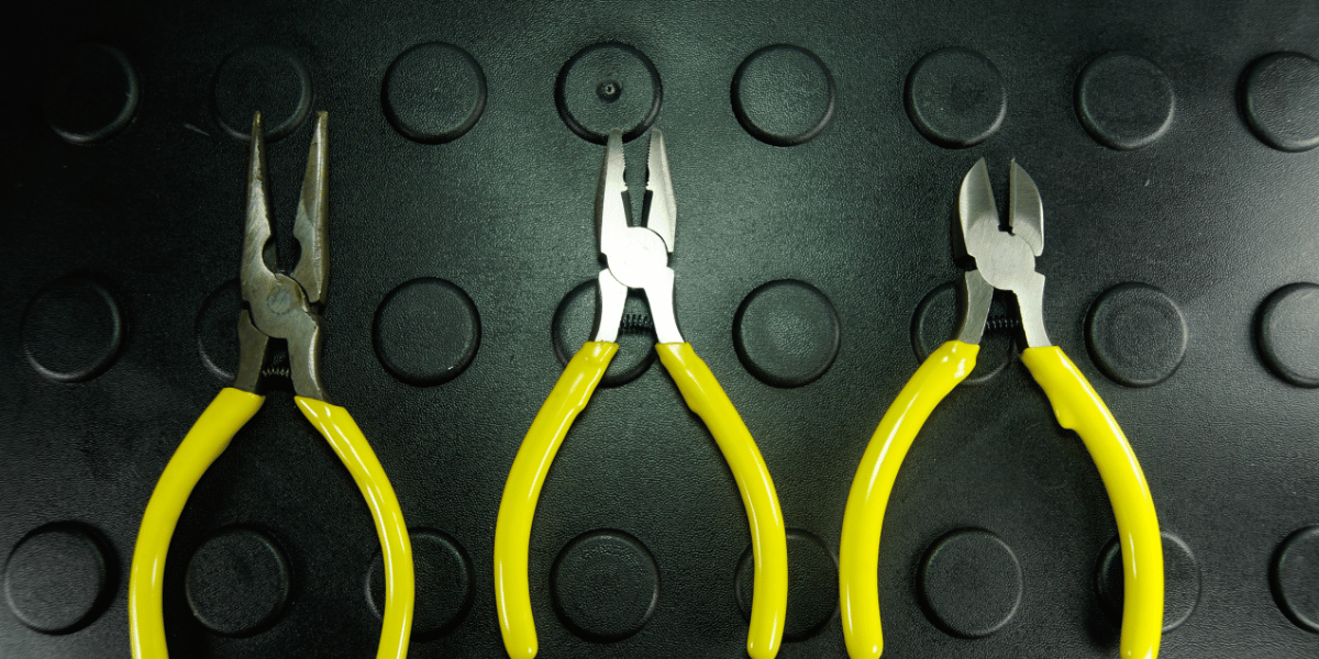 3 yellow-handled pliers against a green backdrop