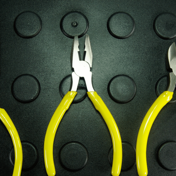 3 yellow-handled pliers against a green backdrop