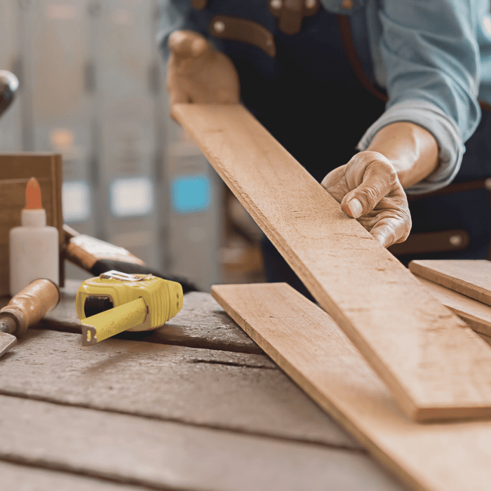 closeup of a woodworker laying out lumber